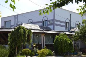 a building with trees in front of it at Hotel AquaMarine in Costinesti