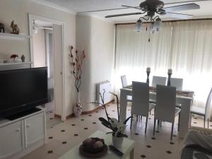 a living room with a table and a dining room at Apartamento entero en la playa san juan Benacantil in Alicante