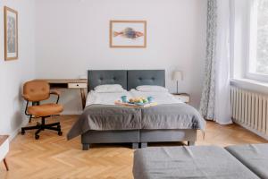 a bedroom with a bed with a desk and a chair at APARTEL Piaseczno in Piaseczno