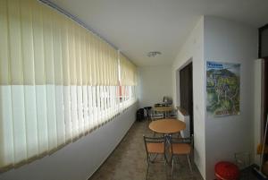 a hallway with a table and chairs in a room at Pansion Ivanka Barac in Međugorje