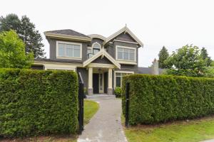 a house with hedges in front of it at Grand House in Westside Vancouver in Vancouver