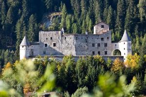 an old castle in the middle of a forest at Schlossbichl in Nauders