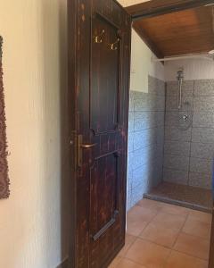 a large wooden door in a bathroom with a shower at S'Imbragu Farm B&B in Tortolì +102 photos