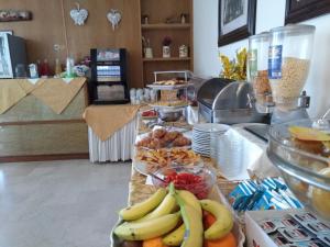 a buffet with bananas and other fruit on a counter at Hotel Tiziana in Rimini