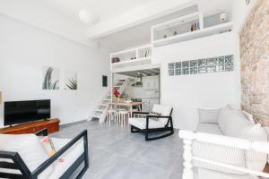 a living room with a couch and a table at Achinos guest house, Skopelos in Skopelos Town