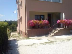 a building with flower boxes on the balcony at Pansion Ivanka Barac in Međugorje +21 photos