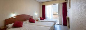Postel nebo postele na pokoji v ubytování Hotel Quino