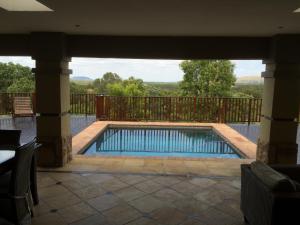a swimming pool in the middle of a patio at Elements golf reserve in Bela-Bela