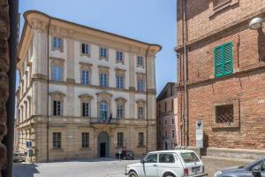 a white car parked in front of a building at Casa del Teatro in Città della Pieve