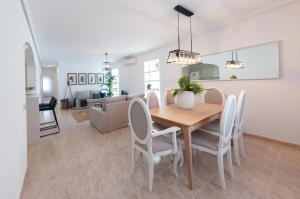 a dining room and living room with a table and chairs at Villa Sunset in Ciudad Quesada