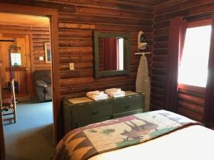 A bed or beds in a room at Bakers Narrows Lodge and Conference Center