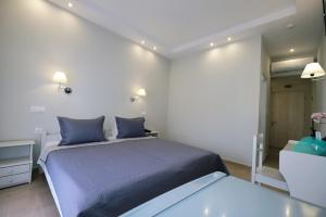 a bedroom with a large bed with blue pillows at Limnia Gi in Myrina