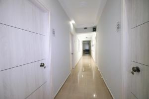 a hallway with white doors and a long corridor at Limnia Gi in Myrina