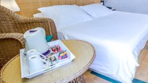 a room with a bed and a table with a coffee maker at Hotel Villa Adriatica - Adults Only in Supetar