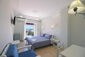 a small bedroom with a bed and a balcony at Limnia Gi in Myrina