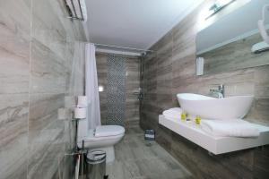 a bathroom with a sink and a toilet at Limnia Gi in Myrina