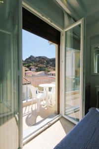 a room with a sliding glass door to a balcony at Limnia Gi in Myrina