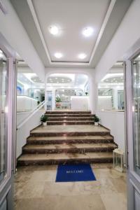 a set of stairs in a building with a welcome mat at Limnia Gi in Myrina