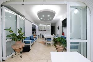 a dining room with blue chairs and plants at Limnia Gi in Myrina