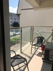 a balcony with two chairs and a table at Apartament Daniela in Năvodari
