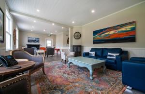 a living room with a blue couch and a table at Hodge Premises in Twillingate