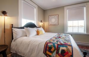 a bedroom with a bed with a quilt on it at Hodge Premises in Twillingate