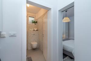 a bathroom with a bed and a toilet in a room at Apartments Flora Trogir in Trogir +73 photos