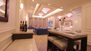 a wine tasting room with a bar with wine bottles at Broad Almkan Apart Hotel in Taif