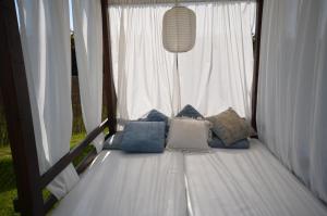 Una cama en una tienda con almohadas. en Hotel Cachada en Sanxenxo