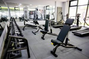 a gym with rows of treadmills and exercise bikes at Apartamente Azzurro on the beach in Mamaia Sat/Năvodari