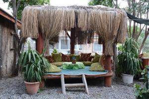 a large couch sitting under a straw umbrella at Cinar Sahil Pansiyon in Dalyan