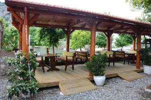 a wooden gazebo with a table and chairs at Cinar Sahil Pansiyon in Dalyan +7 photos