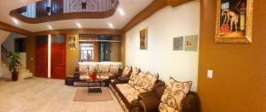 a living room with couches and a couch in a room at Kantu Progreso Inn in Cusco