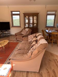 a living room with a couch and a table at Penddaulwyn Uchaf Farm # Carmarthenshire in Nantgaredig