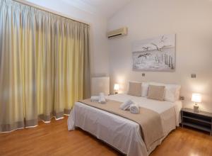 A bed or beds in a room at Evdokia Beach Resort