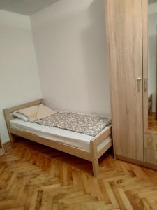 a small bedroom with a bed and a cabinet at Rijeka Rezevici Apartment in Reževići