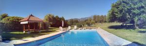 a swimming pool with a gazebo in a park at Monica di Sorbo in Sorbo-Ocagnano