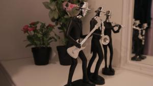 two figurines of a man playing a guitar at برود in Taif