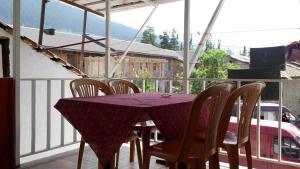 a purple table and chairs on a balcony at Lomari's Guest House in Mestia