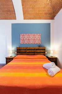 a bedroom with a bed with two towels on it at Stella apartment in Prato