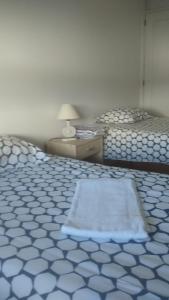 a room with two beds with a rug on the floor at VRS - PORTO SCIENCES FLAT in Porto