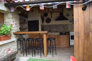 a kitchen with a bar and stools in a kitchen at Casa Rural Javier in Valmuel