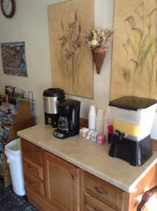 a counter with a coffee maker and a blender on it at Coeur D' Alene Budget Saver Motel in Coeur d'Alene