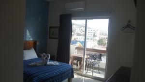a bedroom with a bed and a door to a balcony at Casa del Parque Vallarta in Puerto Vallarta