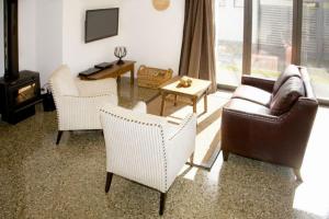 a living room with a couch and chairs and a table at Pembroke Villa in Wanaka
