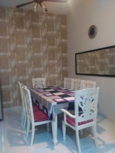 a dining room with a table and four chairs at Selesa Indah Guest House Melaka - Near City Centre in Melaka
