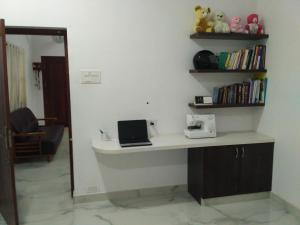 a desk with a laptop on it in a room at Yaa Residency near VIT in Vellore