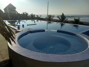a swimming pool on the beach with the ocean in the background at La casa del Argentino in El Hawaii