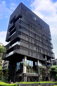 a tall black building with glass windows at Hotel Proverbs Taipei in Taipei