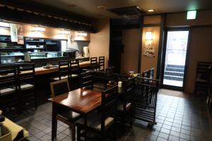 a dining room with a table and chairs at Ueno Touganeya Hotel in Tokyo